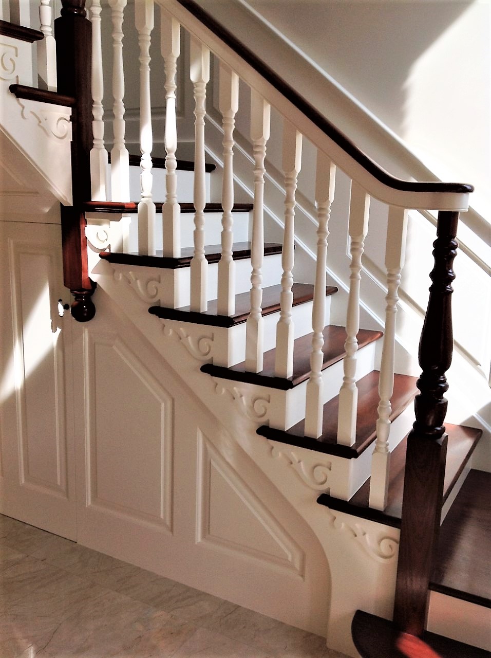 Mahogany and ivory cut string stairs with continuous handrail and wall ...